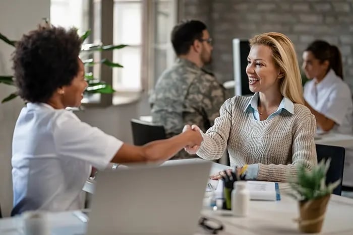 happy-woman-african-american-female-doctor-shaking-hands-after-medical-appointment-clinic